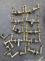 Overview of multiple solid brass door knobs laid out showing variety in handles and styles