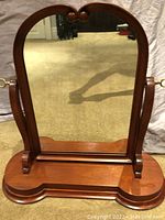 Front view of antique Edwardian swing table mirror showing carved wooden arched frame and mirror glass in good condition.