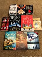 Top view photo showing all ten paperback books arranged on a flat surface. Covers and titles clearly visible.