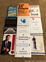 Photo showing all 10 business books arranged in flat lay: 5 hardcover and 5 paperback titles visible with distinct cover designs and authors.