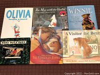 12 childrens hardcover bestselling books shown individually and stacked. Front cover of: Olivia Forms a Band, The Man with the Violin, Winnie, A Visitor for Bear, Buzz Buzz Buzz and The Velveteen Rabbit.