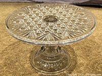 Side angle showing the detailed cut glass pattern and pedestal base of the cake stand.