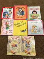 Photo showing front covers of 8 children's books from the set, including a mix of hardcovers and paperbacks with illustrated covers.