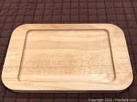 Top view of rectangular rubberwood serving tray showing natural wood grain and recessed center area.