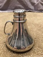 Front view of shiny silver pot-bellied water shaker with handle on side and perforated cap on top.