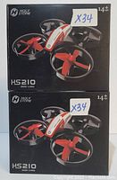 Photo of two boxed Holy Stone HS210 mini drones stacked vertically showing packaging and model details.