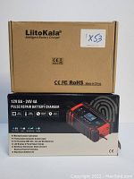 Photo of the LiitoKala charger product box with branding, model details and key specifications including pulse repair and temperature detection features.