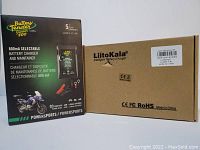 Box packaging of Battery Tender Junior 800 charger with branding and features, and cardboard box of LiitoKala charger showing brand and compliance markings.