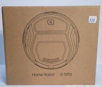 Photo of the cardboard box containing the home robot vacuum cleaner with Free Move technology. Box features line art of the robot vacuum and product branding.