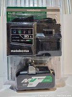 Photo shows Metabo HPT multi-voltage rapid charger and multi-voltage Li-ion battery pack in original packaging with electrical cord for charger visible.