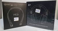 Photo of two boxed headphones side by side: Cowin Meidong HE6 neck mounted earphones and Coinsound E7 active noise cancelling headphones, both unopened.