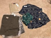 Lot includes two blue Club Monaco patterned shirts and a green patterned shirt, beige Polo golf shirt, and multiple Roots khaki pants in various sizes.