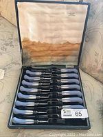 Full set of 8 knives and 8 forks in original fitted case, satin-lined lid stained