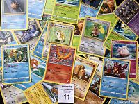 Top side of the Pokemon cards, showing different character cards with attributes and images.