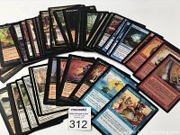 Spread out assortment of Magic: The Gathering cards showing various colors and card artwork.