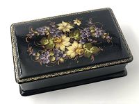 Top and angle view showing hand-painted floral design and gold border on black background.