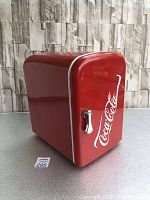 Front and side view of Coca-Cola mini fridge showing red exterior and logo