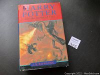 Photo of front dust jacket cover showing Harry Potter flying with dragon and title text.