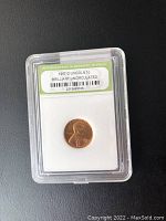 Front side of the 1957-D Lincoln 1 cent coin graded Brilliant Uncirculated, showing obverse with Lincoln portrait and grading label by International Numismatic Bureau.