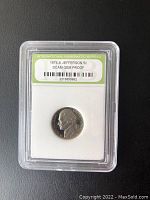 Obverse side of 1974-S Jefferson 5 cent coin, showing profile of Thomas Jefferson, graded and encapsulated in plastic slab by International Numismatic Bureau.