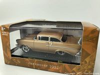 New in box diecast model of a 1957 Chevrolet car in a brown and gold M2 Machines window display box.