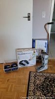 Full view of all items including arm weights, leg brace, circulation booster box, bed assist handle box, and cane.