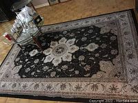 Full view of rectangular Turkish Vegas Collection rug with glass table on top.