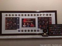 Wide view of the large framed NHL Canadian Legends display with multiple commemorative hockey pucks and images of three players in vintage jerseys.