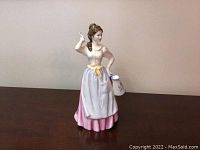 Front view of the Royal Doulton Dairy Maid figurine showing detailed clothing and milk jug.