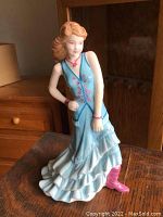 Front angled view of Royal Doulton 'Paige' figurine in blue dress with pink boots and accessories.
