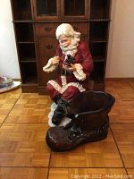 Large dark-colored boot shown separately, size approximately 30 inches in length, displaying surface condition and material.