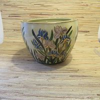 Full view of the oval vintage ceramic flower pot with floral raised design in blue and pink with gold detailing.