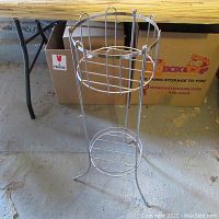 Full photo of the metal jardinière plant stand showing its structure, size, and design.