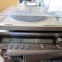 Onkyo receiver beneath Pioneer turntable showing overall setup
