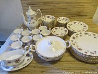 Full set of Royal Osborn china including coffee pot, teacups, saucers, dinner plates, side plates, bowls, covered serving dish, gravy boat with attached plate, and sugar and creamer.