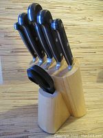 Wooden utensil block containing five knives and one pair of scissors, showing overall lot contents.