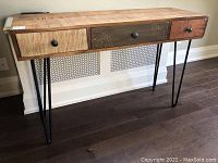 Front view showing overall desk and three-drawer arrangement