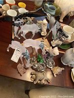 Top-down photo showing the vanity mirror and assorted collector figurines including frosted glass animals and ceramic pieces
