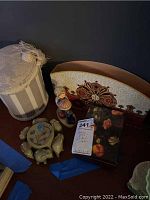 Full view of lot with all items including Goebel music box figurine, marble elephant trinket box, letter holder, and decorative container