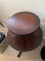 Close-up of the round top tier showing the decorative border and surface scratches.