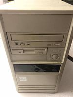 Front of beige tower showing CD-ROM drive bay, 1.44MB floppy drive and power button