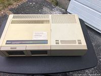 Full view of beige Coleco ADAM computer console showing top cartridge slot and cassette compartments
