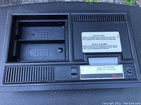 Top view showing cartridge slot, controller ports, and power switch area with instructional labels.