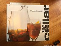 Box front displaying product name and image of pitcher and glass with iced beverage and lemon slice