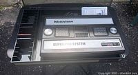 Top view of Intellivision Super Pro System console in black plastic game organizer, showing integrated numeric keypad controllers and system name plate.