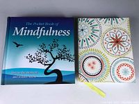 Front covers of the mindfulness book and the patterned journal side by side