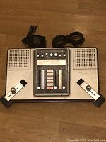 Top view of Unisonic Tournament 2000 console with integrated paddles and attached cables