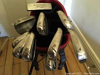 Top view of nine club heads showing numbering 4–9, A (pitching), P and Odyssey putter