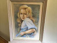 Full view of the framed pastel portrait showing the young blonde girl with a white textured outfit.