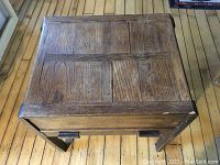 Top view of the wooden table showcasing the paneled wood surface with natural aged finish.